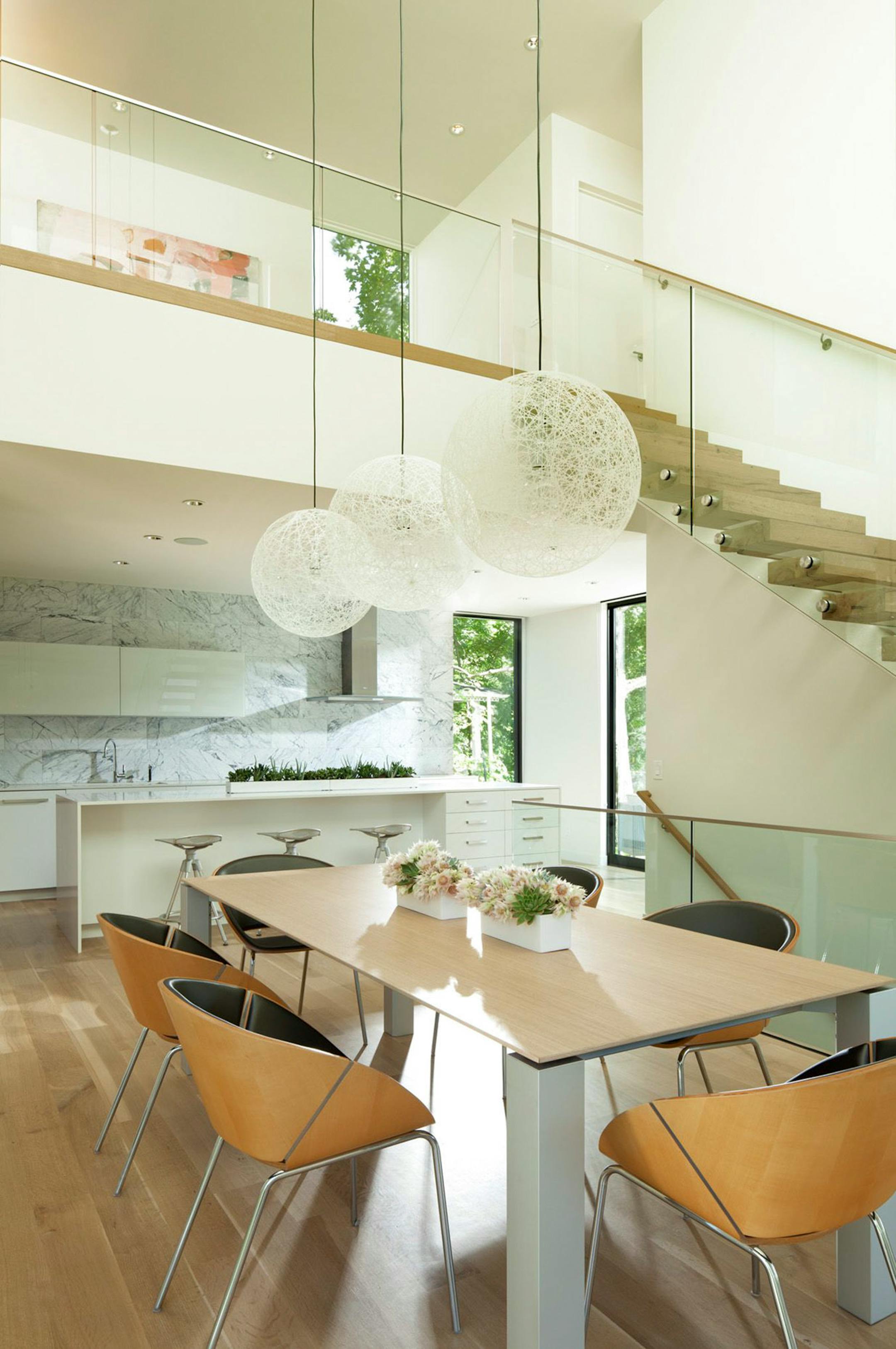 Another view of the open kitchen and dining area. Mod Moooi Random fiberglass globes add visual energy.
