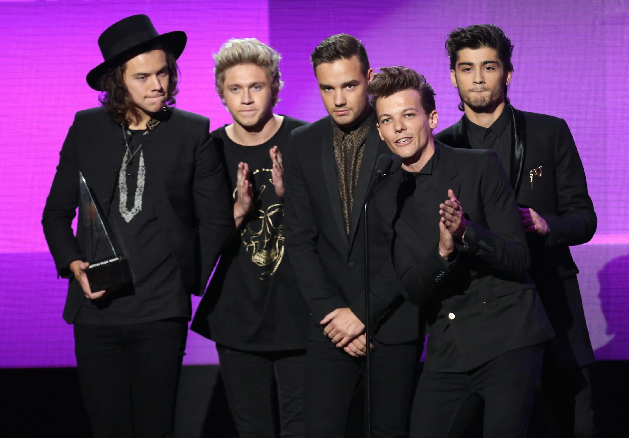 Harry Styles, from left, Niall Horan, Liam Payne, Louis Tomlinson and Zayn Malik of the musical group One Direction accept the award for pop/rock band, duo or group on stage at the 42nd annual American Music Awards at Nokia Theatre L.A. Live on Sunday, Nov. 23, 2014, in Los Angeles.