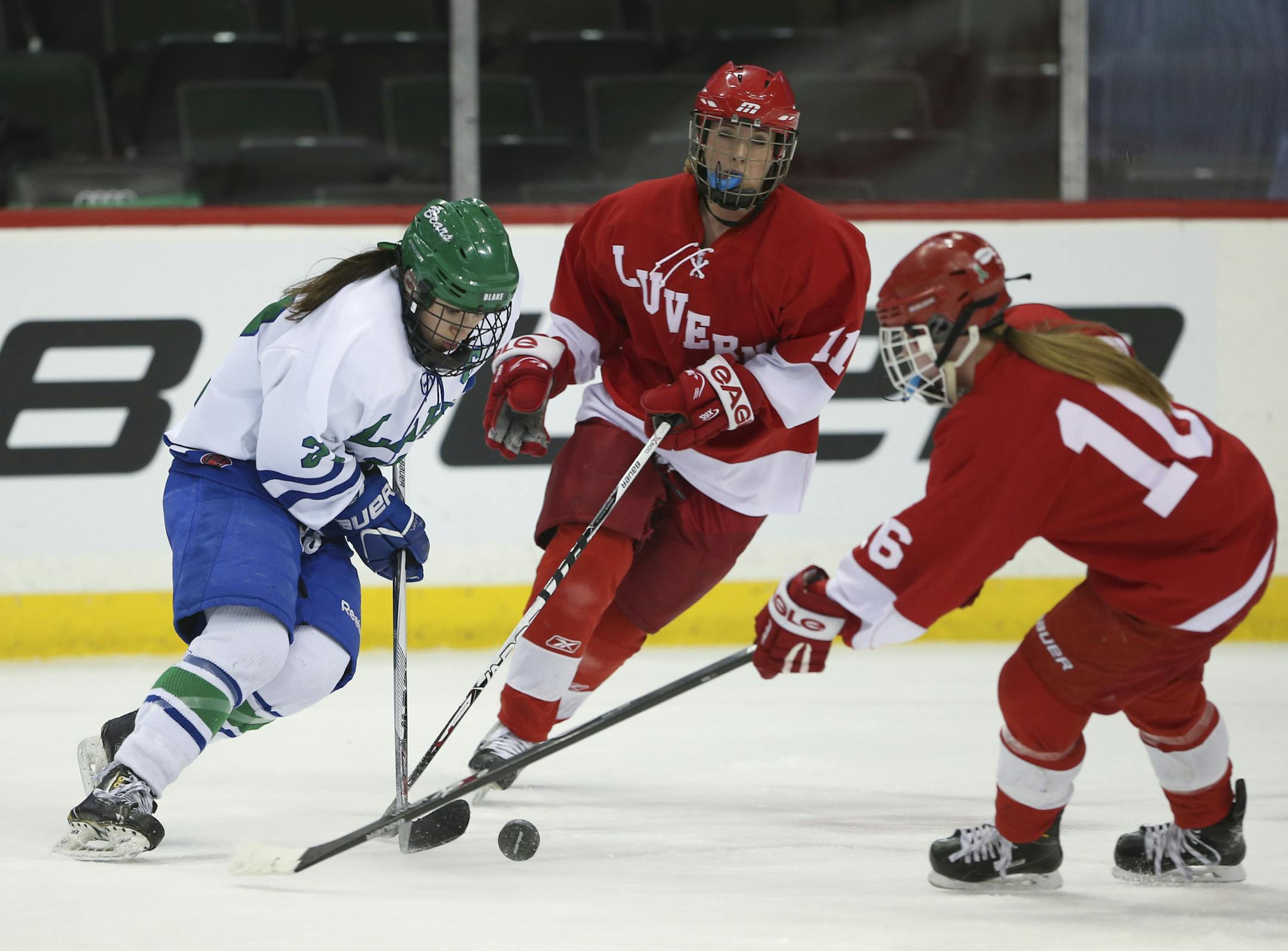 Blake's Carly Bullock tried to stickhandle past Luverne defender Maykayla Sterrett (16) in the first period Wednesday night. ] JEFF WHEELER ï jeff.wheeler@startribune.com Luverne faced Blake in a quarterfinal game of the 2016 Class A Girls' State Hockey Tournament at Xcel Energy Center in St. Paul Wednesday night, February 27, 2016.
