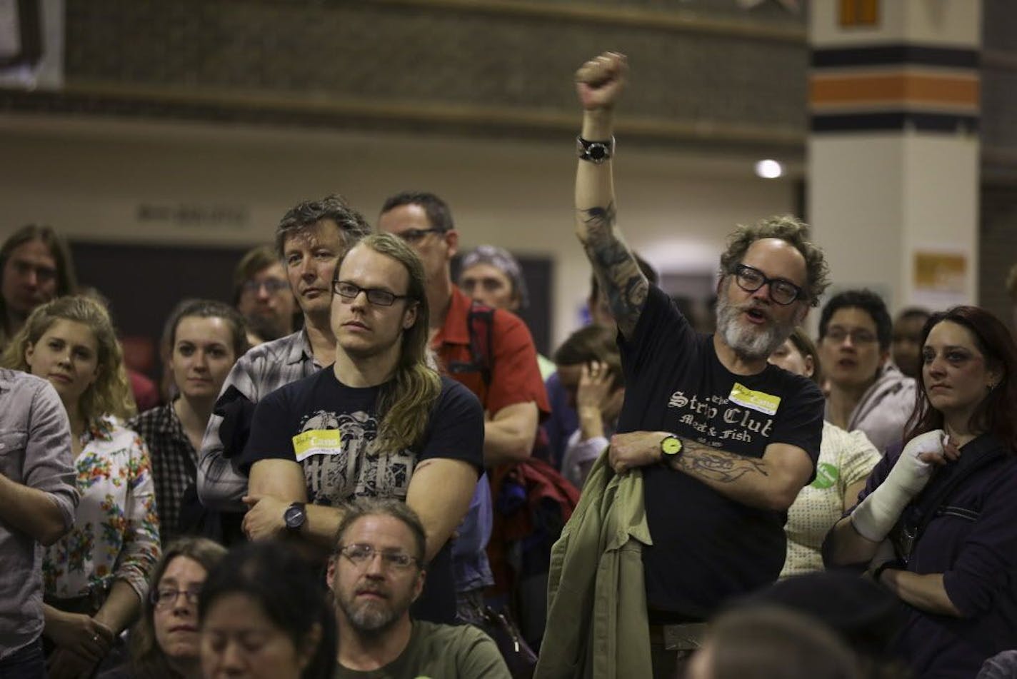 James Christenson, raising his fist in support of remarks by a Park Board candidate, was among those who attended the Ward 9, Precinct 2 caucus at South High School.