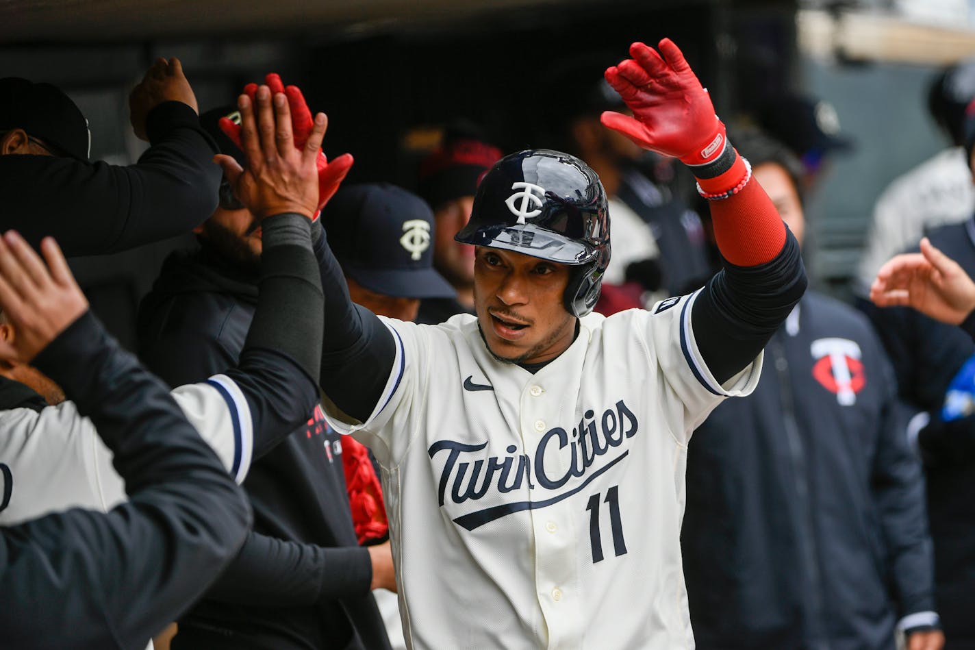 Minnesota Twins' Jorge Polanco celebrates in the dugout after hitting a home run against Washington Nationals pitcher Patrick Corbin during the fourth inning of a baseball game, Sunday, April 23, 2023, in Minneapolis. (AP Photo/Craig Lassig)