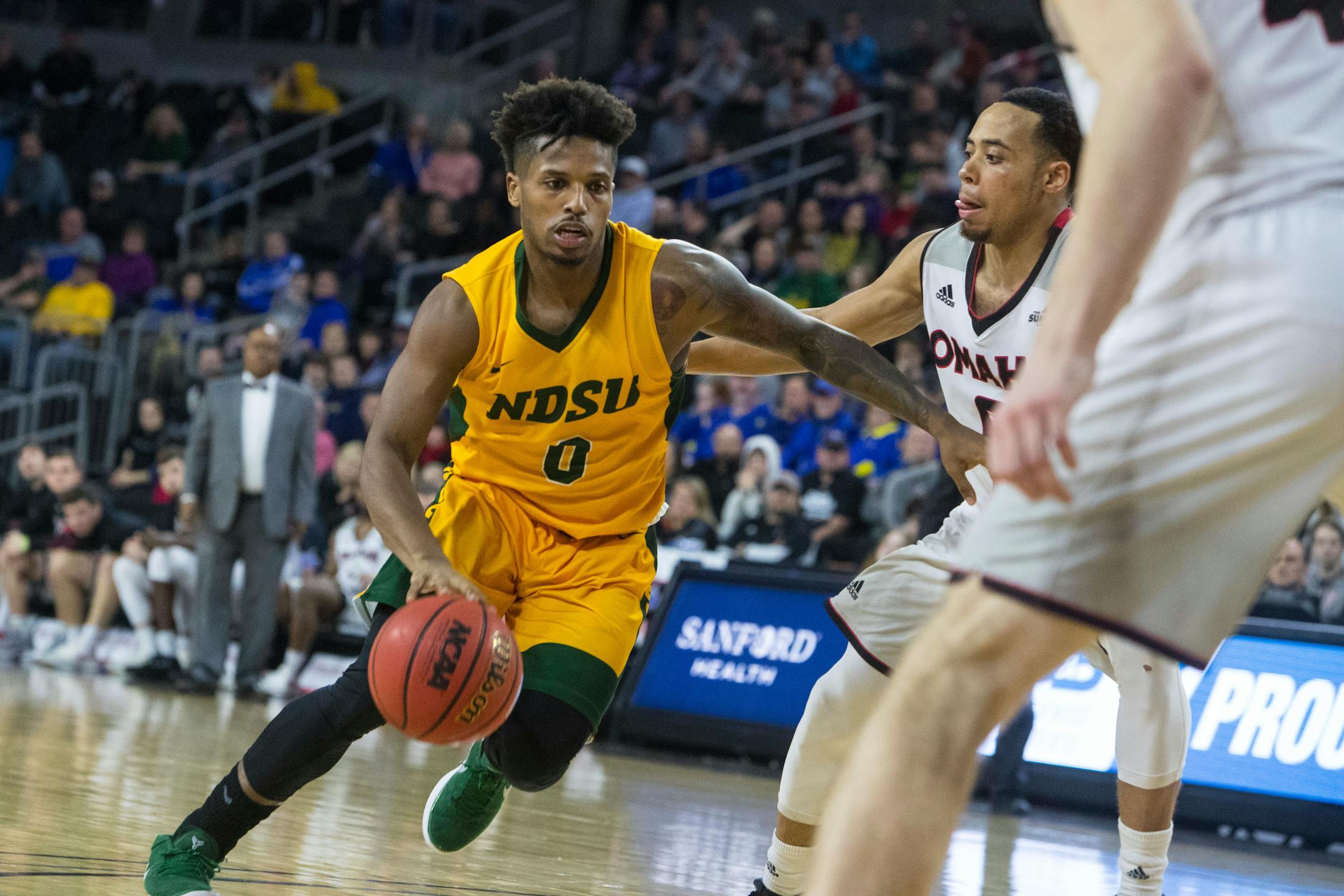 North Dakota State's Vinnie Shahid drives next to an Omaha player during Tuesday's Summit League championship