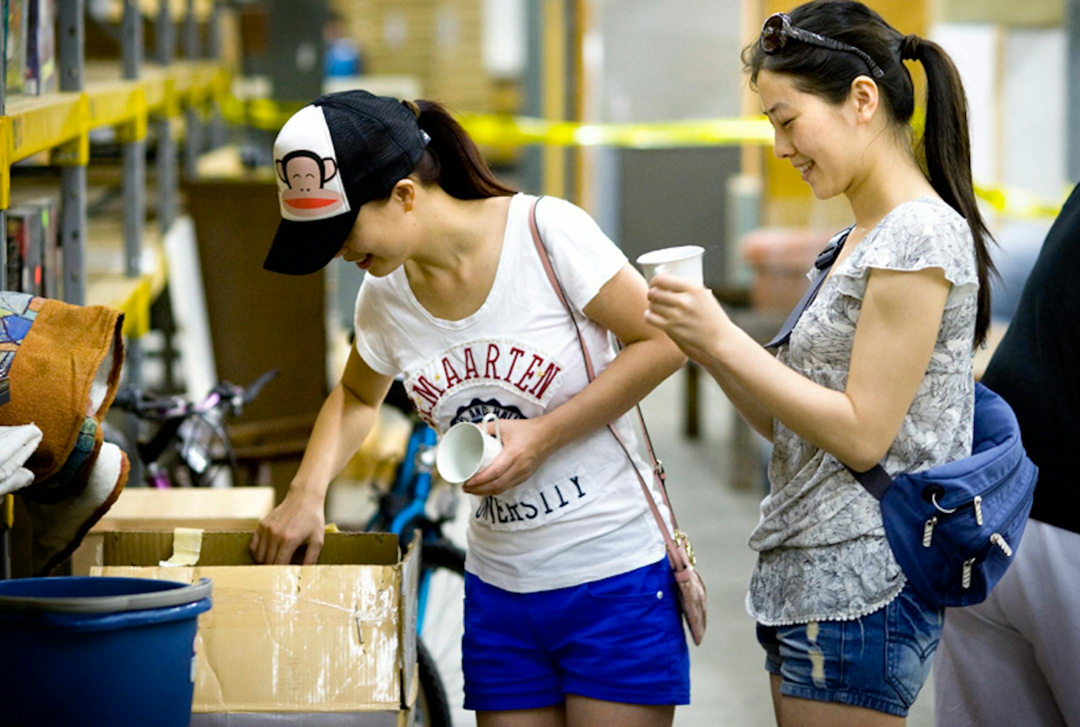 Grace Huang and Lori Luo looked through a set of dishes at the Move-In Move-Out free store. It's run by the Southeast Como Improvement Association in an effort to reduce massive amounts of curbside waste left by students moving in and out of dorms and apartments.