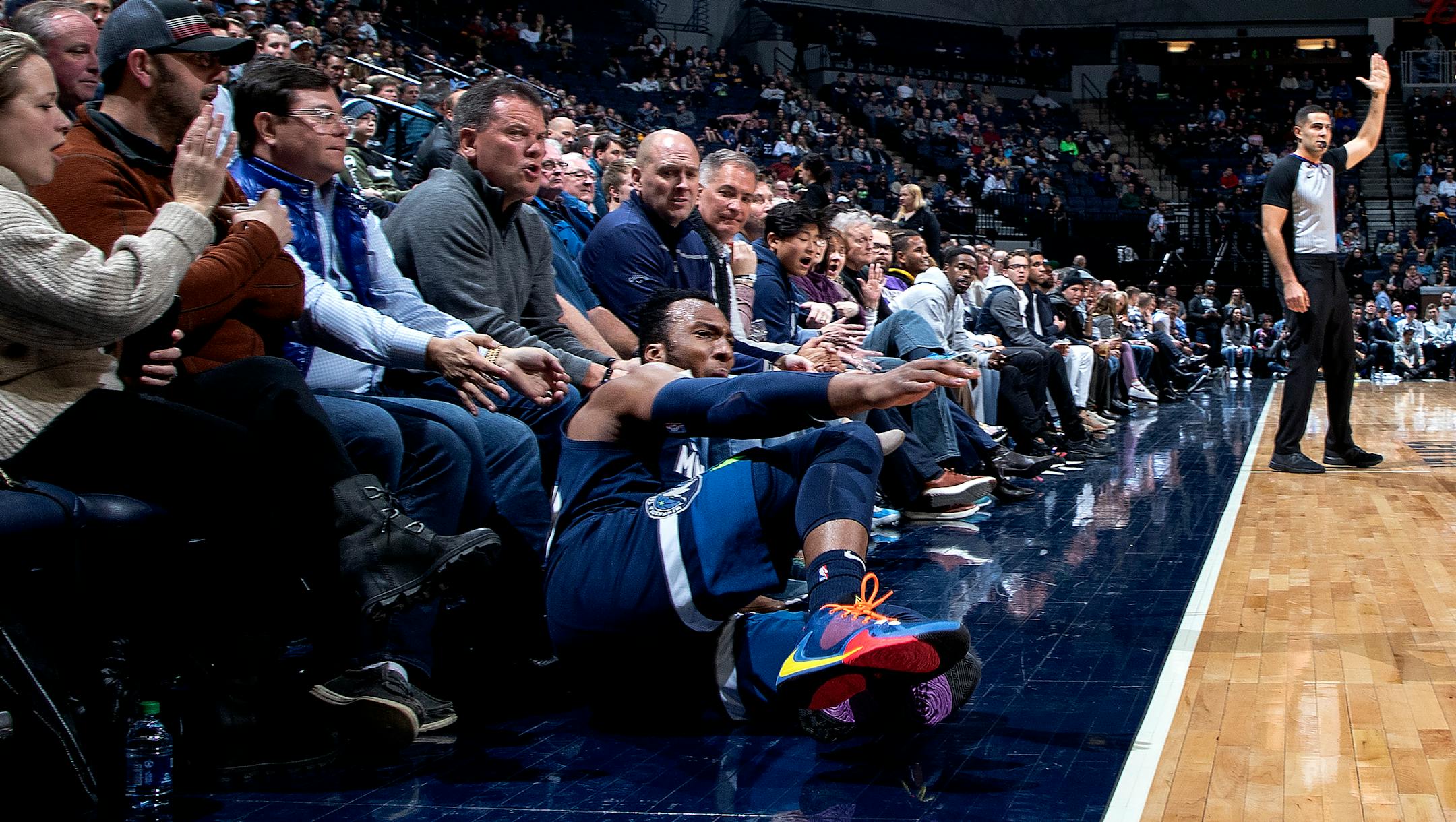 Wolves guard Josh Okogie fell into the front row after making a three-pointer in the second quarter of a 107-100 loss to the Nuggets on Monday night.