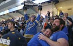 A St. Louis Blues fan at a hoists a replica Stanley Cup in celebration at a watch party in the Enterprise Center in St. Louis after the Blues scored a