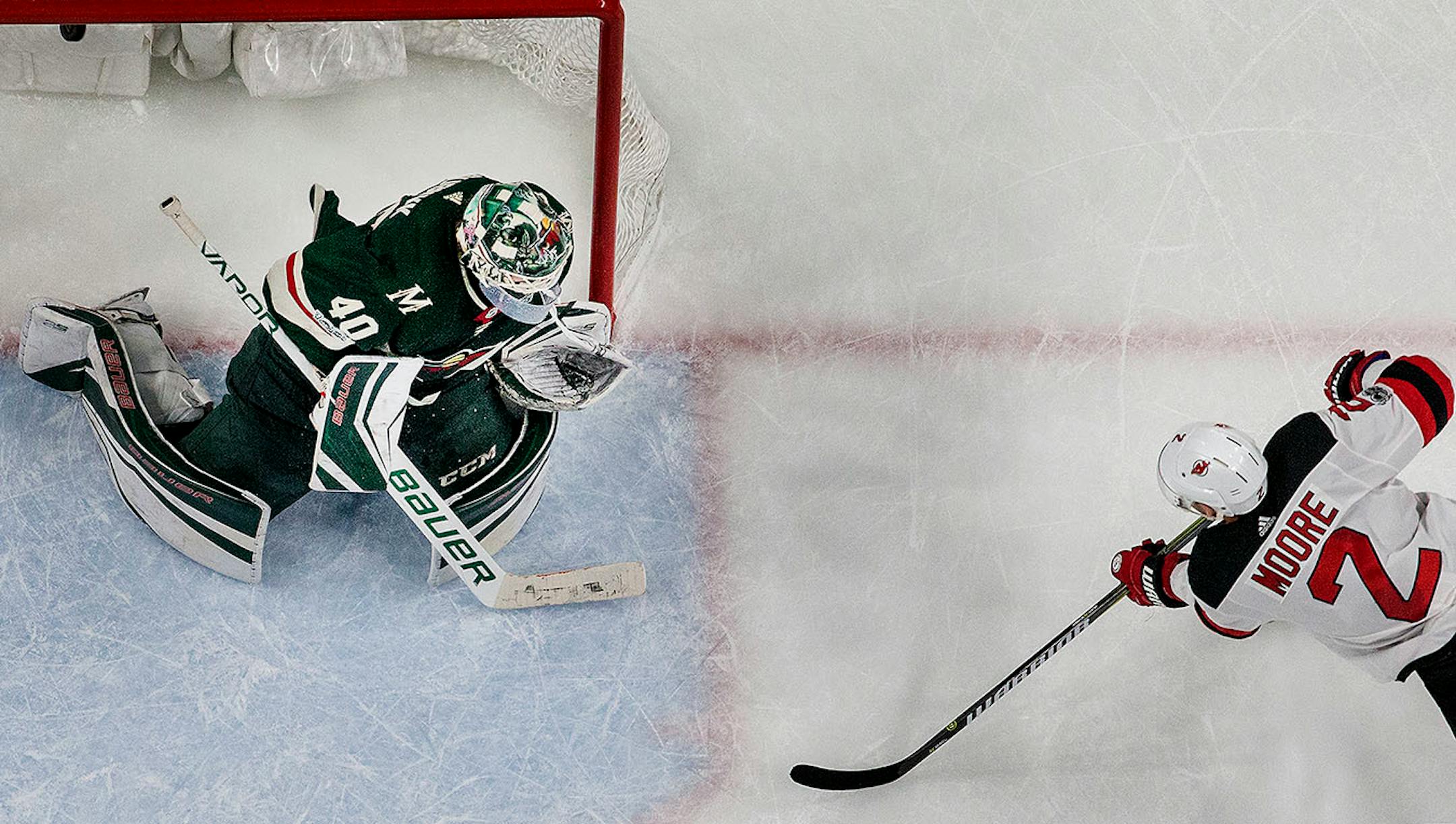 John Moore (2) shot the puck past Wild goalie Devan Dubnyk (40) to win the game in overtime.