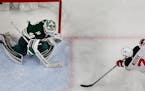 John Moore (2) shot the puck past Wild goalie Devan Dubnyk (40) to win the game in overtime.