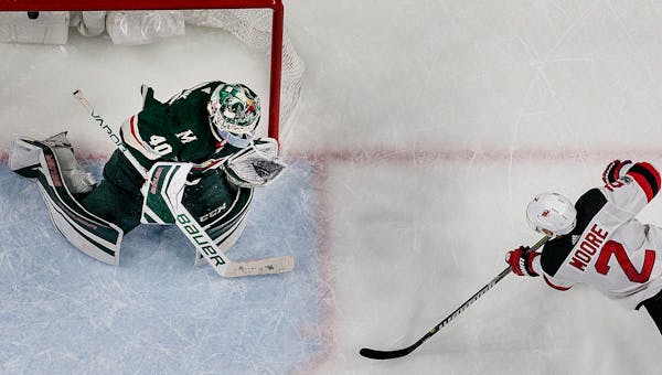 John Moore (2) shot the puck past Wild goalie Devan Dubnyk (40) to win the game in overtime.