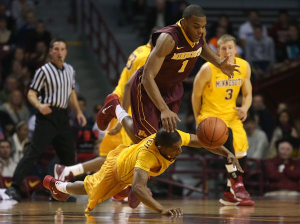 Deandre Mathieu and Andre Hollins dove after a loose ball during the first half of the Gophers' scrimmage at Williams Arena in October.