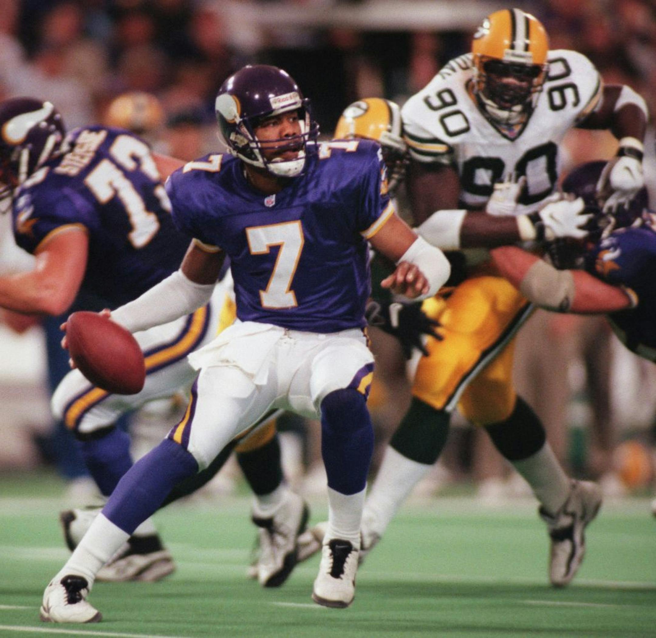 With good protection, Randall Cunningham keeps his cool under pressure from the Packer defense in the 4th quarter.