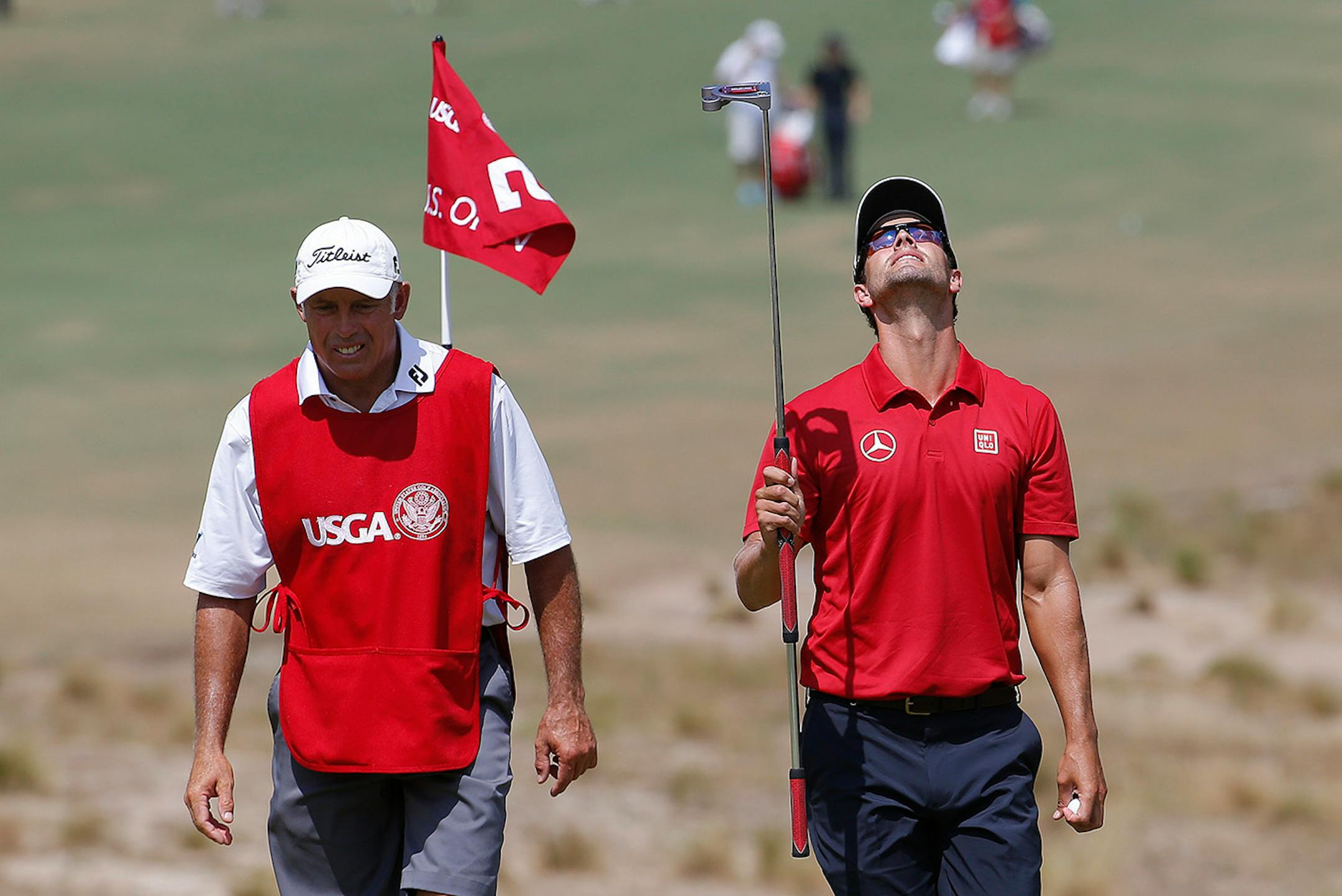 Adam Scott, of Australia, right, walks on the fifth green during the third round of the U.S. Open golf tournament in Pinehurst, N.C., Saturday, June 14, 2014.