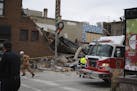 Firefighters and rescue personnel work at the scene of building collapse in Sioux Falls, S.D., Friday, Dec. 2, 2016. A fire official says rescue worke