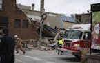 Firefighters and rescue personnel work at the scene of building collapse in Sioux Falls, S.D., Friday, Dec. 2, 2016. A fire official says rescue worke