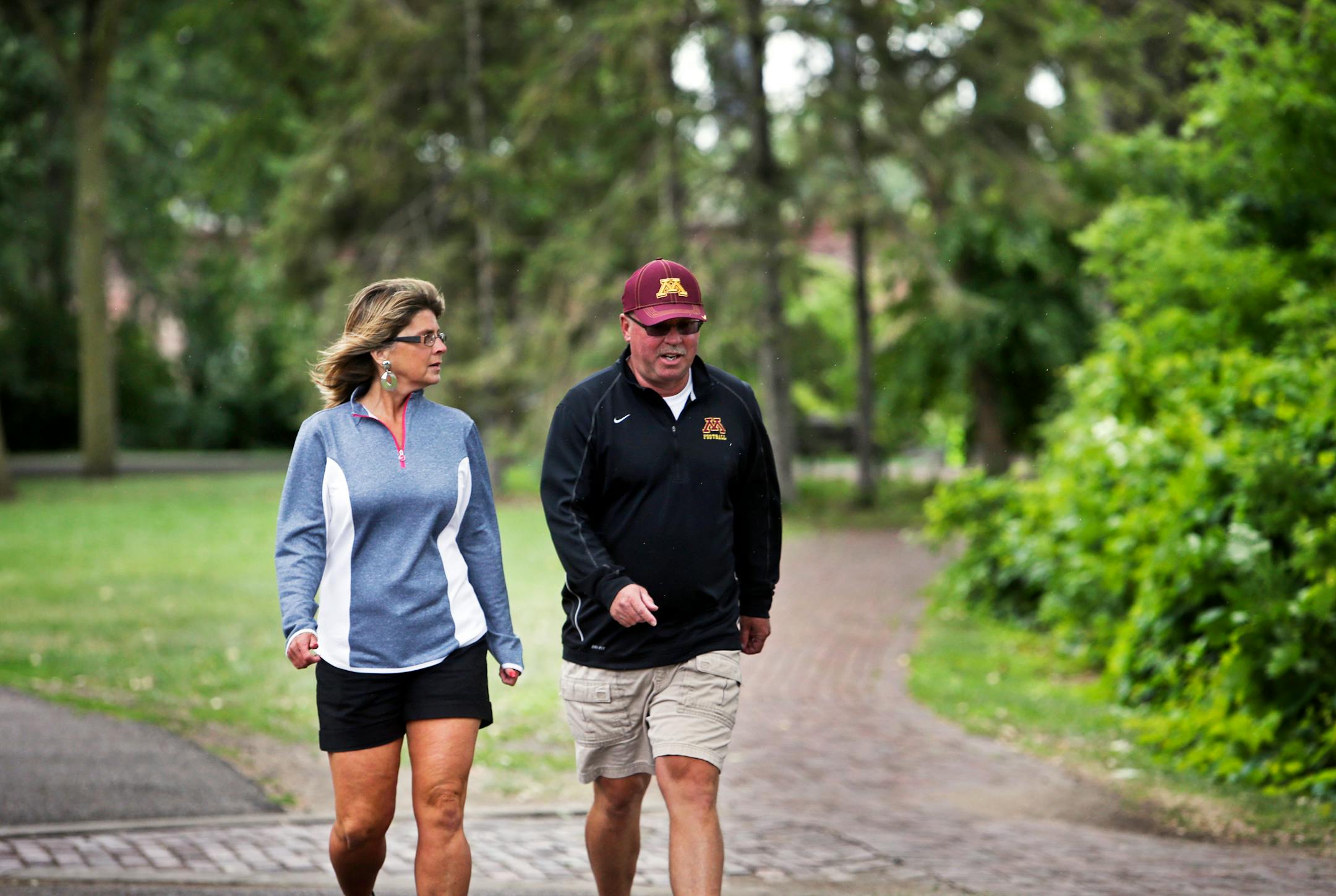After taking time off to attend to his health, Jerry Kill and his wife, Rebecca, walked the trail along the Mississippi River near downtown Minneapolis in 2013.