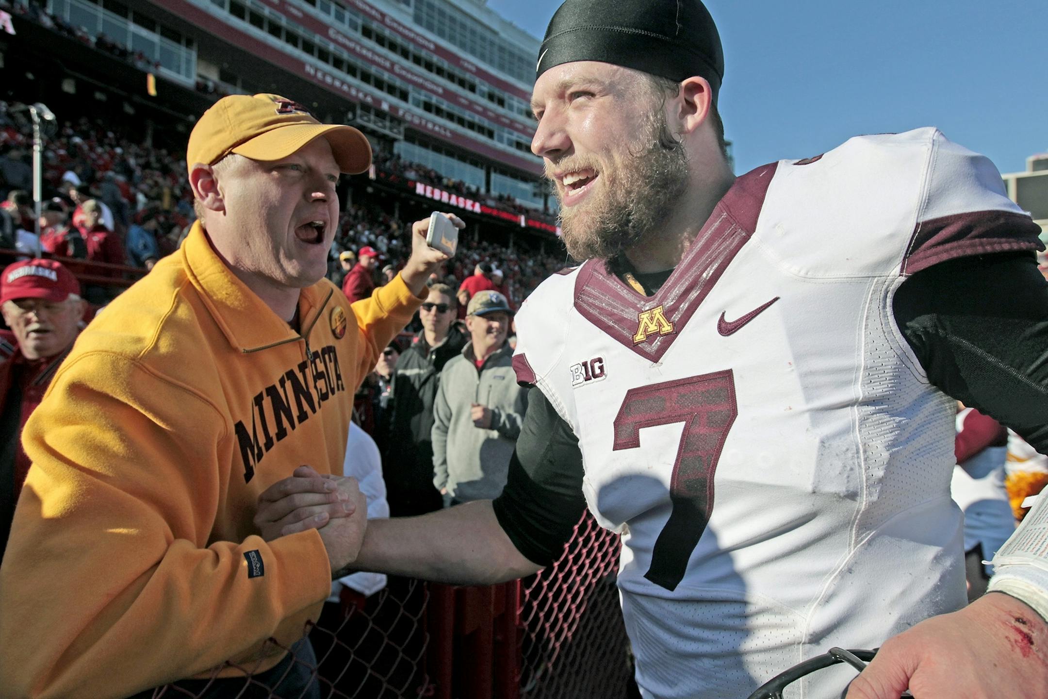 Minnesota's quarterback Mitch Leidner (7) was greeted by fans as he celebrated the Gophers 28-24 win over Nebraska at Memorial Stadium, Saturday, November 22, 2014 in Lincoln, NE.