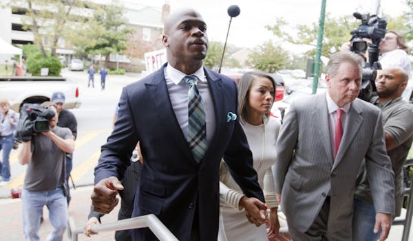Minnesota Vikings running back Adrian Peterson arrives at the courthouse with his wife Ashley Brown Peterson, for an appearance Tuesday, Nov. 4, 2014,