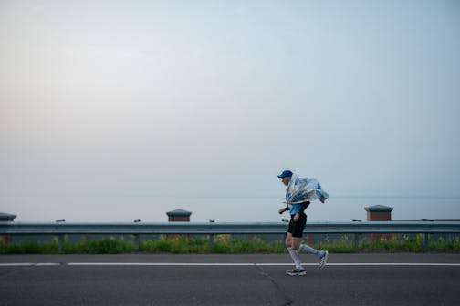 A participant warms up for the Garry Bjorklund Half Marathon along Scenic Highway 61 in between Two Harbors and Duluth, Minn.