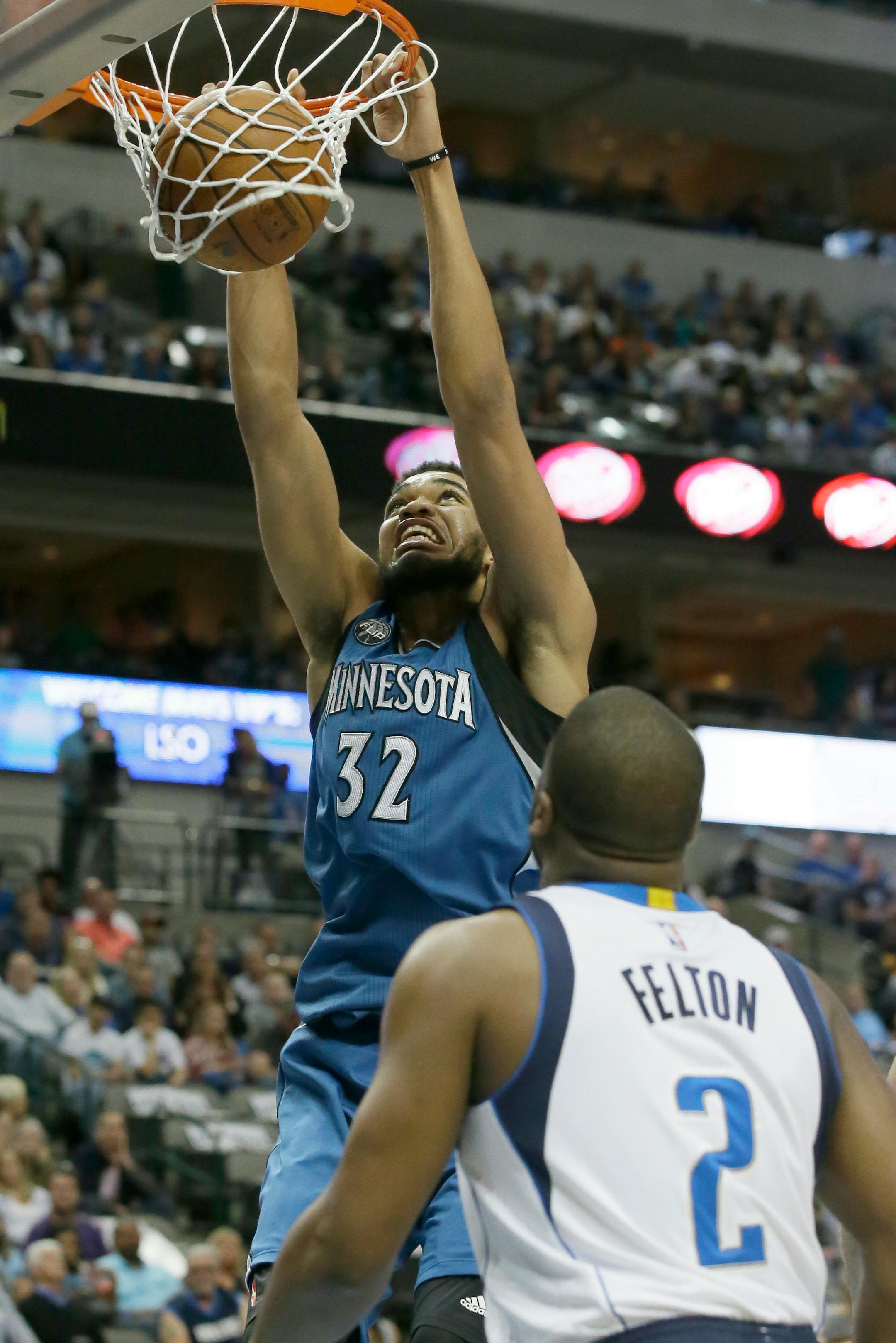 Minnesota Timberwolves center Karl-Anthony Towns (32) slam dunks in front of Dallas Mavericks guard Raymond Felton (2) during the first half of an NBA basketball game Sunday, Feb. 28, 2016, in Dallas. (AP Photo/LM Otero)