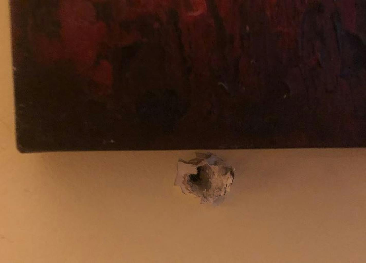 The bullet hole in the living room wall of a New Hope family. Credit: Submitted photo