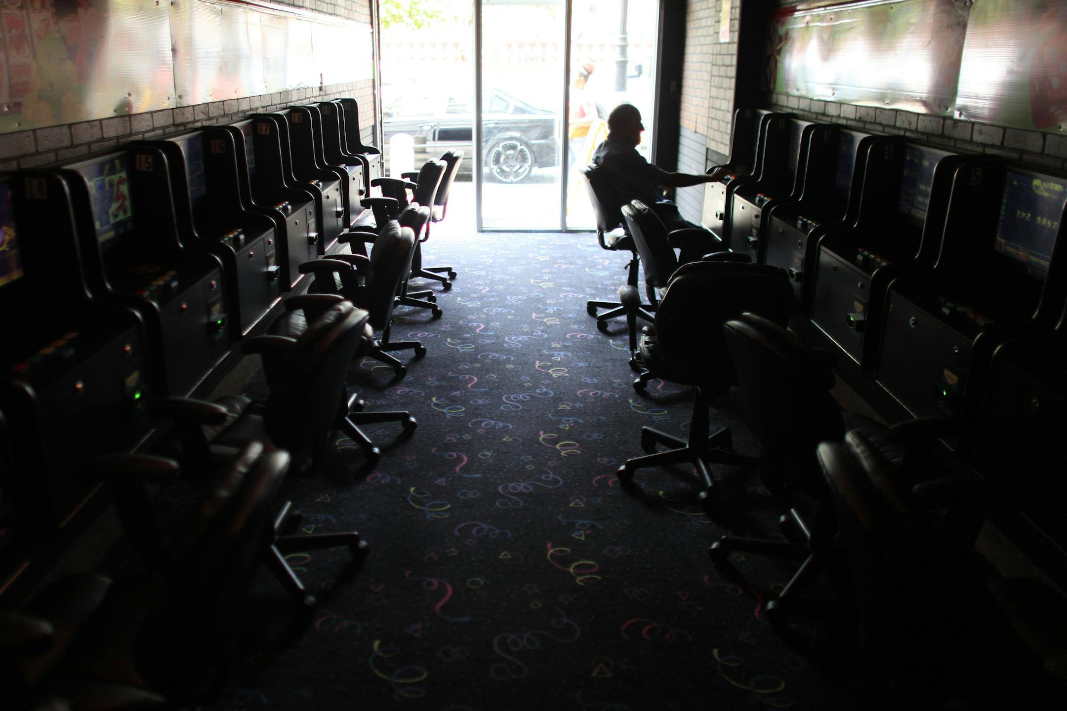 A man plays an electronic slot machine at a virtual casino in the Rio Piedras neighborhood of San Juan, Puerto Rico, Wednesday, July 1, 2015, the day a 11.5% sales tax goes into effect, the highest of any U.S. state. The island's administration has been pushing for Congress to let the government and public agencies seek bankruptcy protection, while the White House has said no one is contemplating a federal bailout of Puerto Rico. (AP Photo/Ricardo Arduengo)