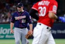 Texas Rangers' Nomar Mazara jogs to the dugout as Minnesota Twins relief pitcher Tyler Duffey (21) celebrates getting Isiah Kiner-Falefa to fly out wi