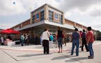Customers line up before a ribbon cutting and preview of one of nine Aldi grocery stores in the Houston area in 2013.