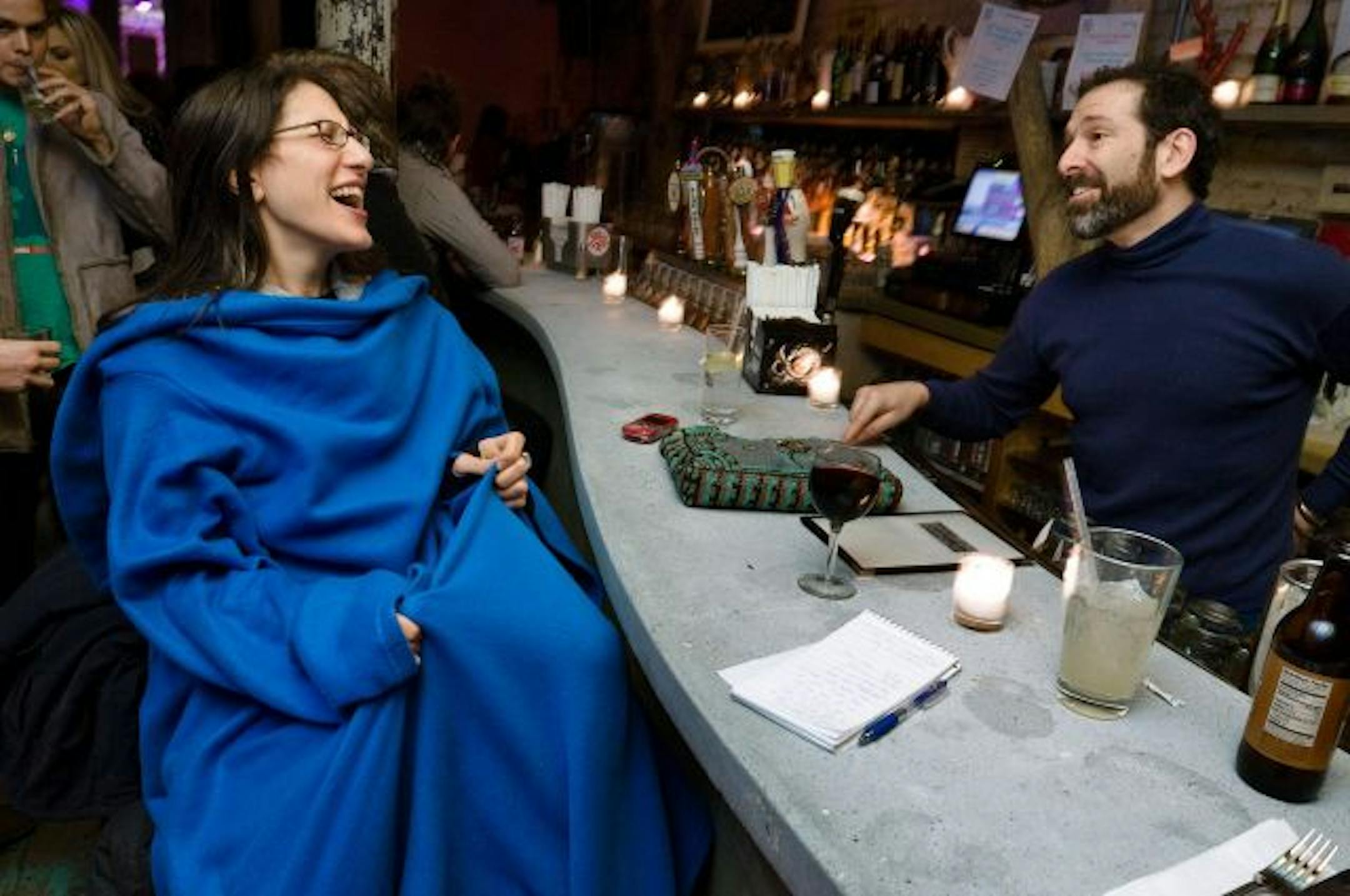 The infomercial that ate our brain: While this Snuggie-wearing woman at a bar in Lower Manhattan seems comfortable and trendy, would you wear one to a football game?