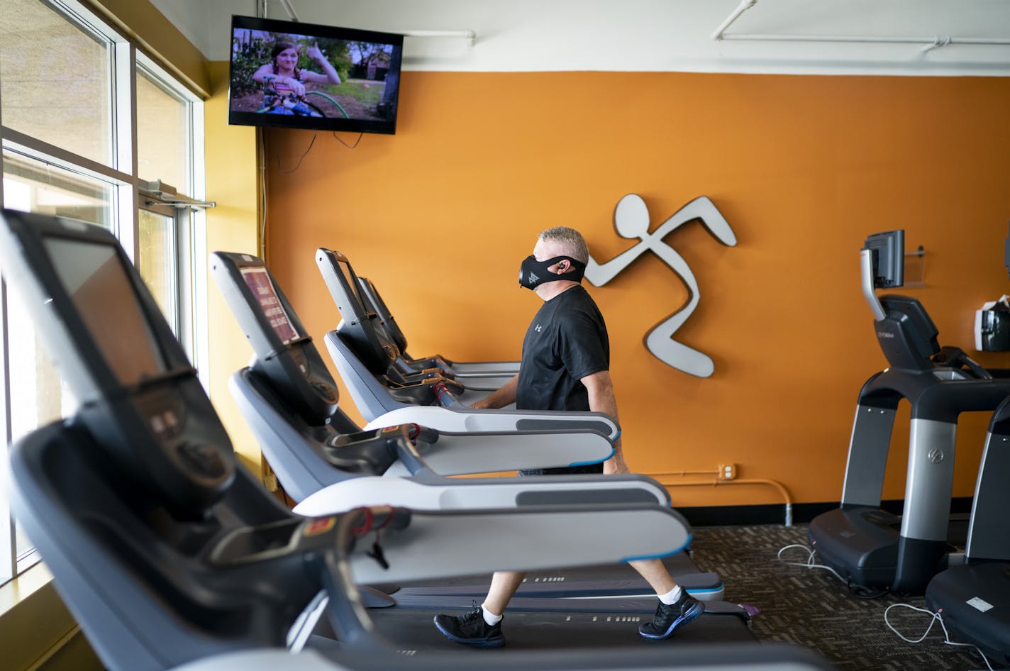 Brett Kraus of Oakdale was eager to work out on the first day gym's could reopen in Minnesota at Anytime Fitness in Oakdale, Minn., on Wednesday, June 10, 2020. Kraus had lost 15 pounds at a winter boot camp that had ended in March and said he gained 10 of it back as he stayed home for Covid-19. He is wearing an elevation mask to improve his workout with an added filter. ] RENEE JONES SCHNEIDER renee.jones@startribune.com