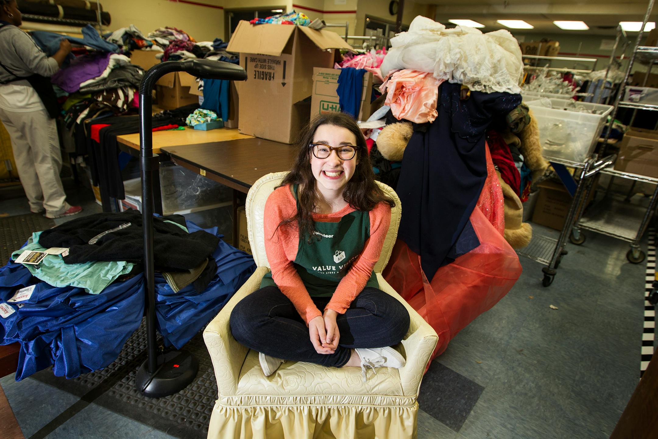 Payton Puerzer sits on a donated chair in the back room at Arc's Value Village thrift store in Richfield, where she volunteers. Photo by Courtney Perry