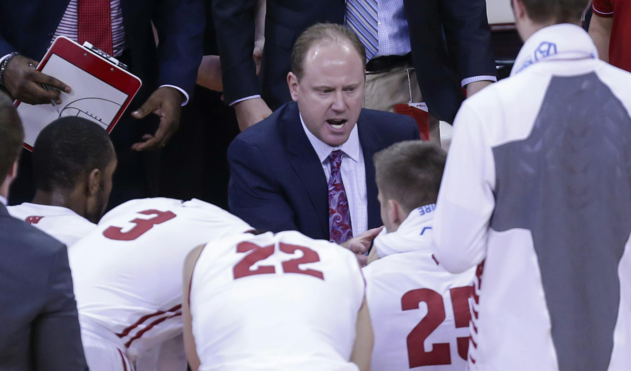 Wisconsin coach Greg Gard, center, talks to his team during a timeout in the first half of an NCAA college basketball game against Michigan on Tuesday, Jan. 17, 2017, in Madison, Wis. (AP Photo/Andy Manis)