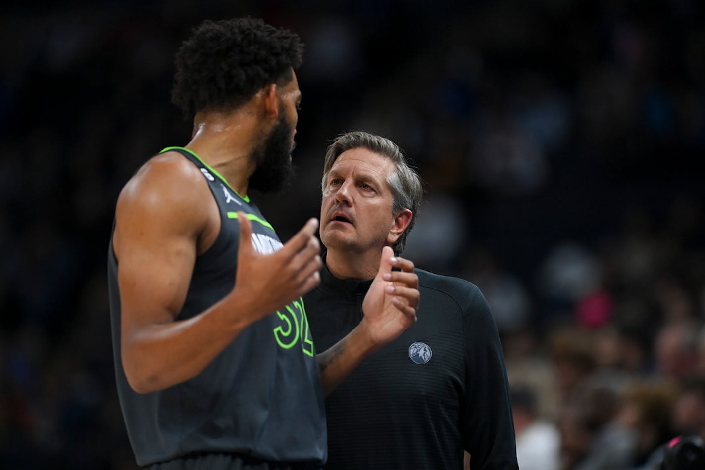 Minnesota Timberwolves head coach Chris Finch talks things over with center Karl-Anthony Towns during a game earlier this season.