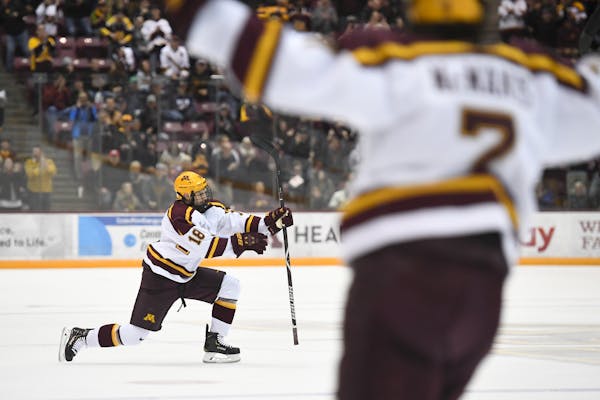Gophers defenseman Clayton Phillips and forward Brannon McManus celebrated McManus' second goal against Minnesota Duluth. They have had to adjust to t