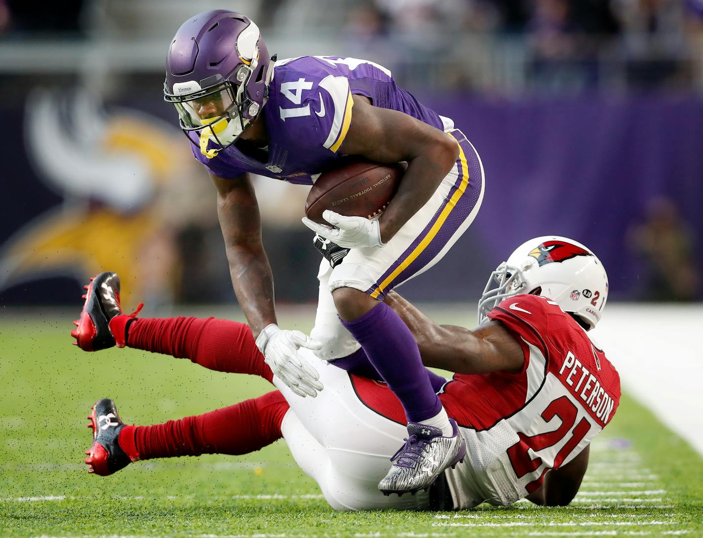 Stefon Diggs (14) was tackled by Patrick Peterson (21) in the third quarter.