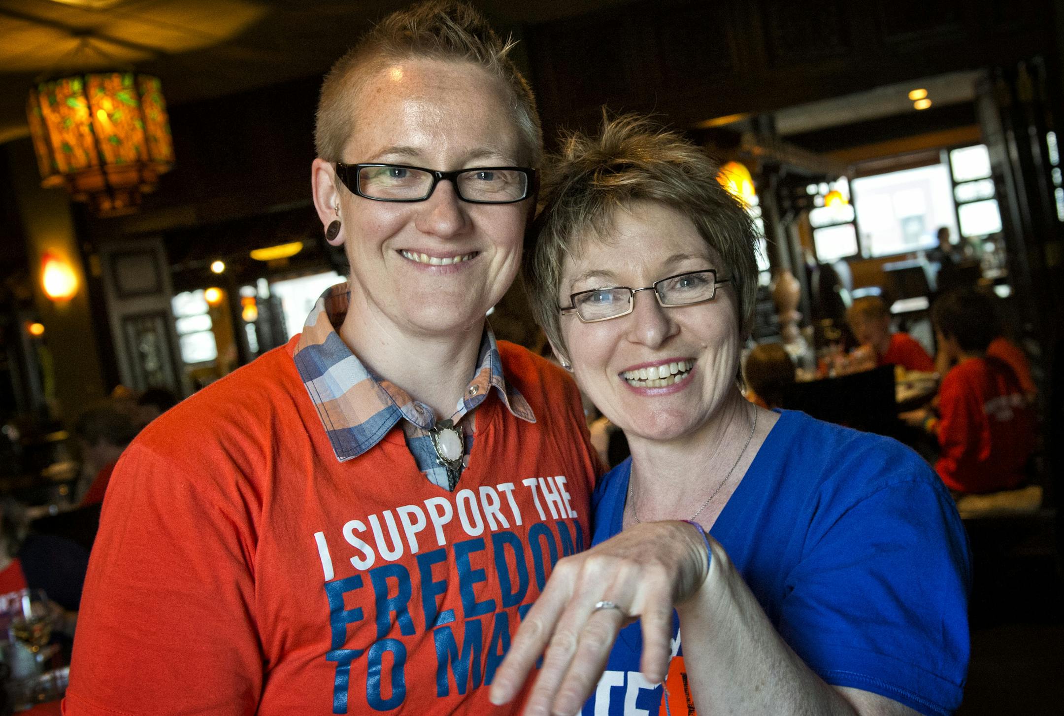 Awen and Kit Briem got engaged in the Minnesota Capitol right after the Senate voted to allow same-sex marriages in Minnesota. Kit showed off her engagement ring while the couple celebrated their engagement with friends at Mai Village restaurant in St. Paul, a mile away from the Capitol. Monday, May 13, 2013 ] GLEN STUBBE * gstubbe@startribune.com
