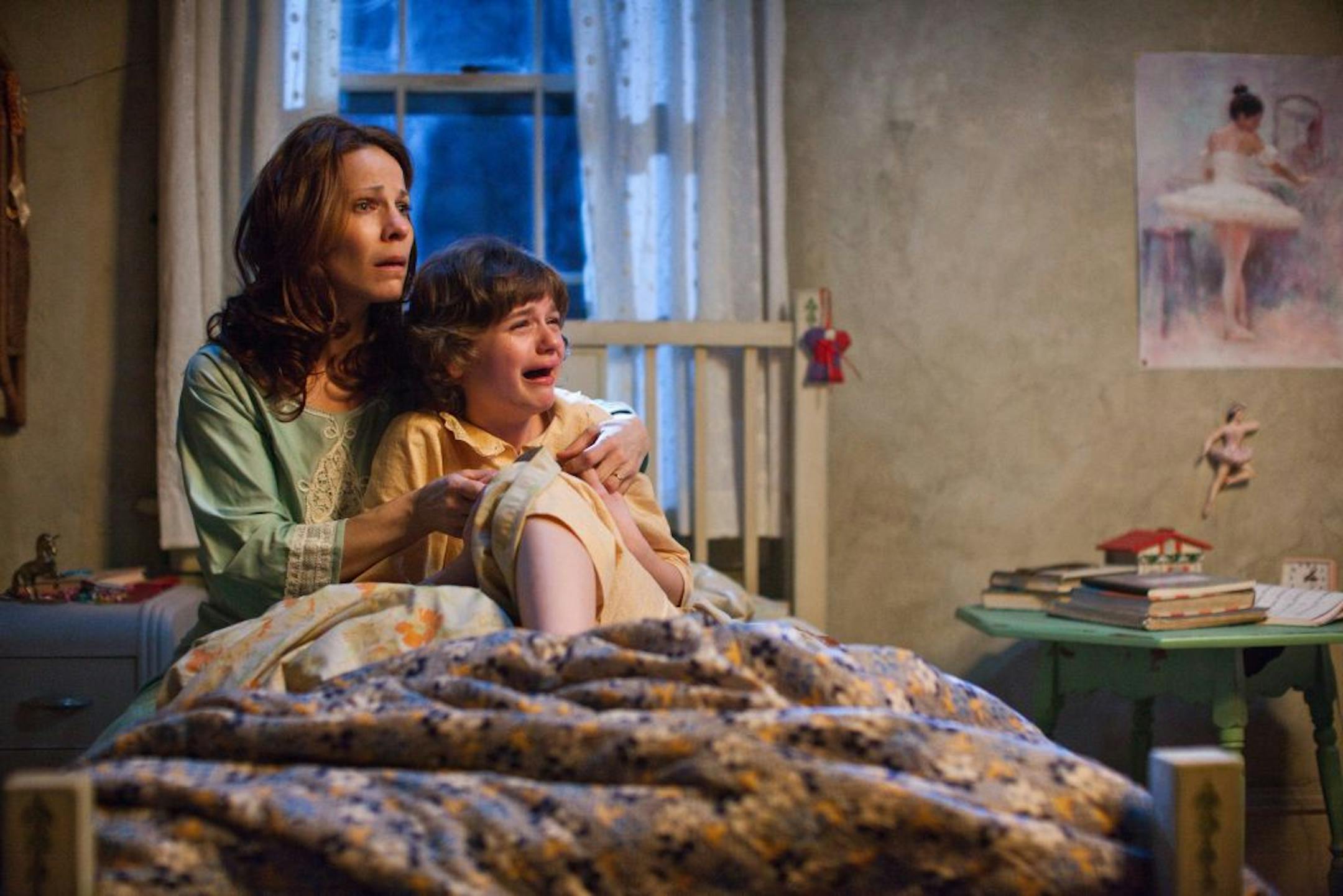 In this publicity image released by Warner Bros. Pictures, Lili Taylor portrays Carolyn Perron, left, and Joey King portrays Christine in a scene from "The Conjuring." The films opens nationwide on Friday, July 19.