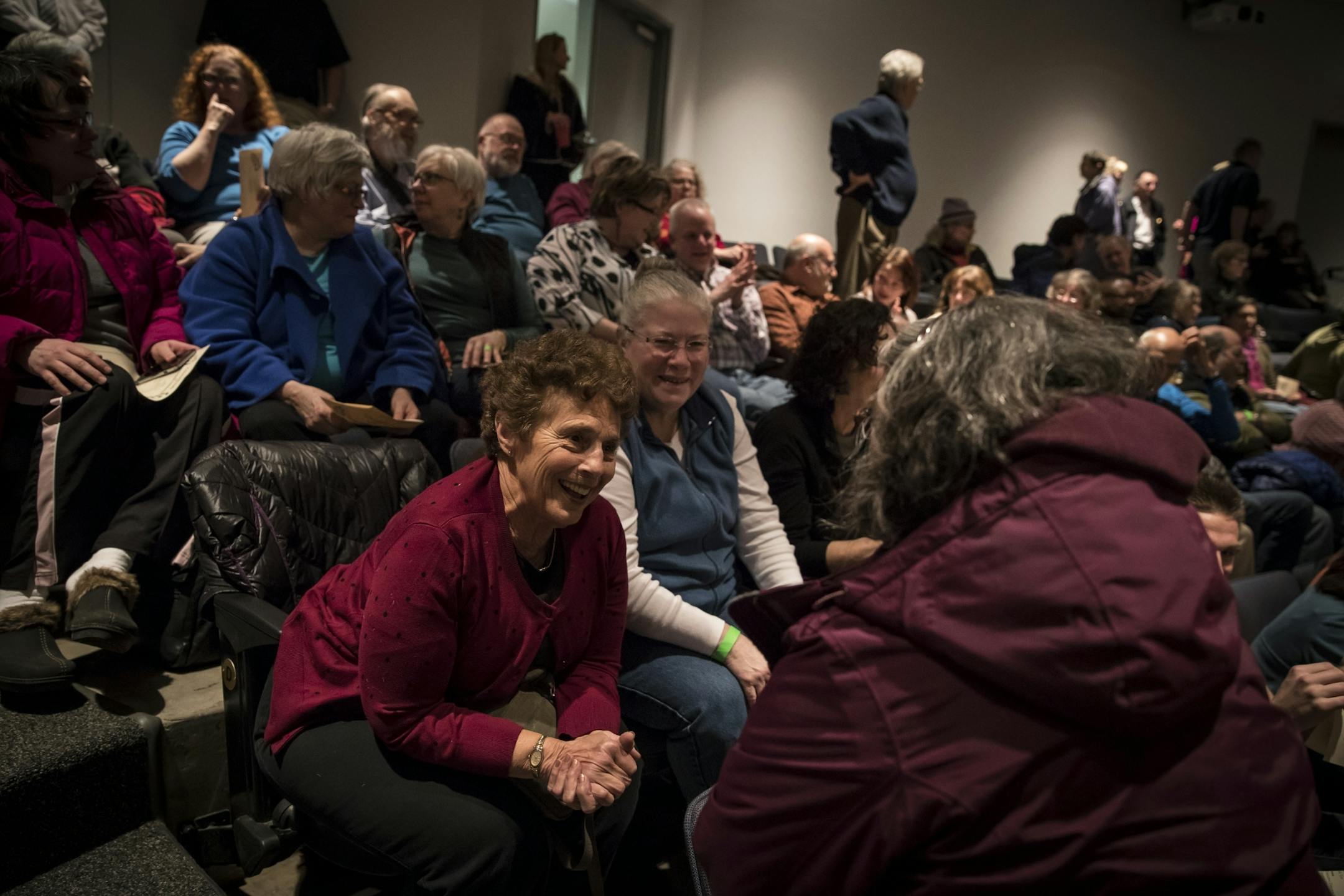 Sheila Harrow Brod (in red in center) greeted people around her as she and packed crowd took a minute to greet each other during an interfaith rally at the Highland Park Community Center on Thursday, March 2, 2017, in St. Paul, Minn.
