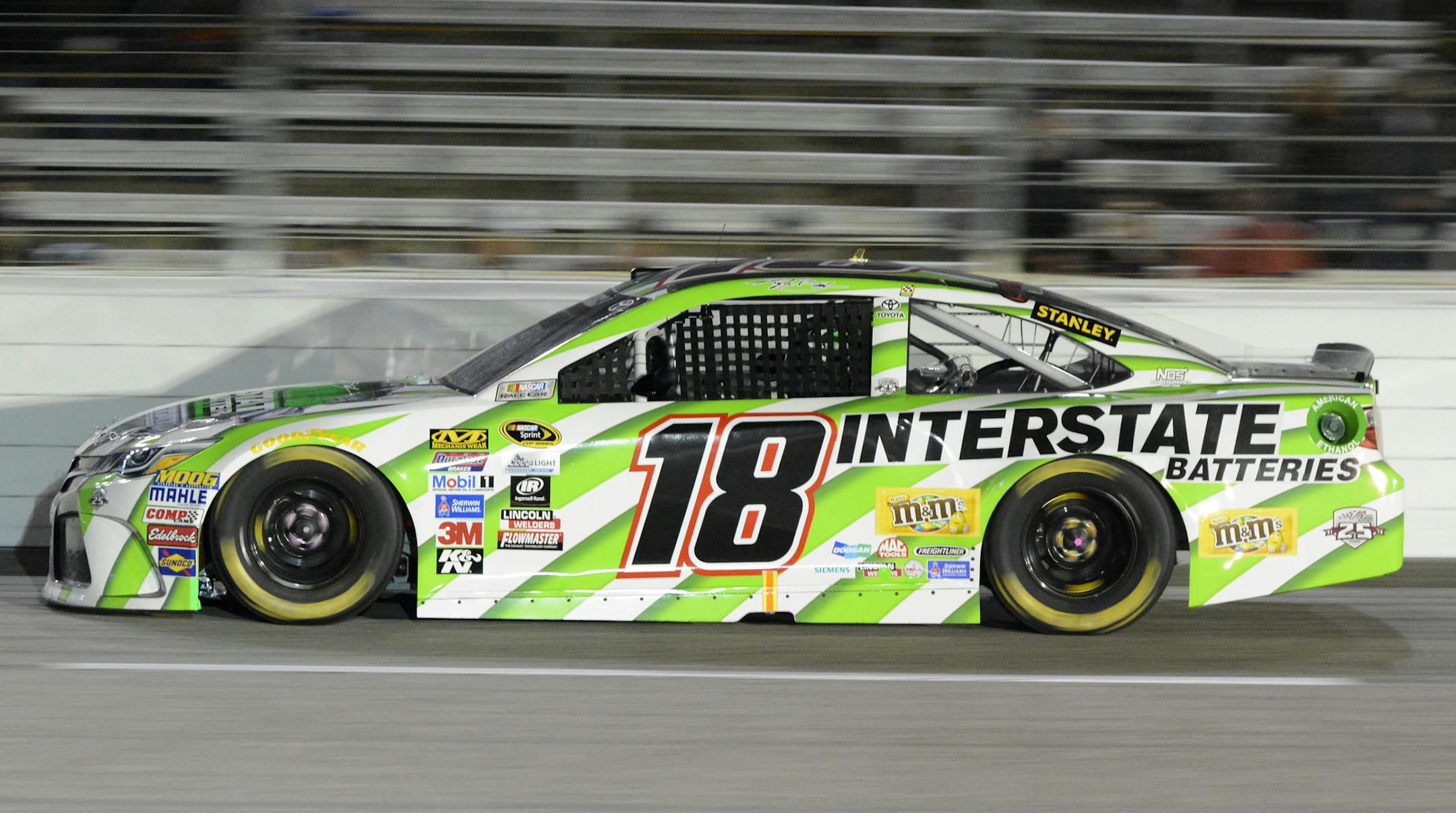 Kyle Busch (18) drives through turn 4 during the NASCAR Sprint Cup Series auto race at Texas Motor Speedway in Fort Worth, Texas, Saturday, April 9, 2016. (AP Photo/Larry Papke)