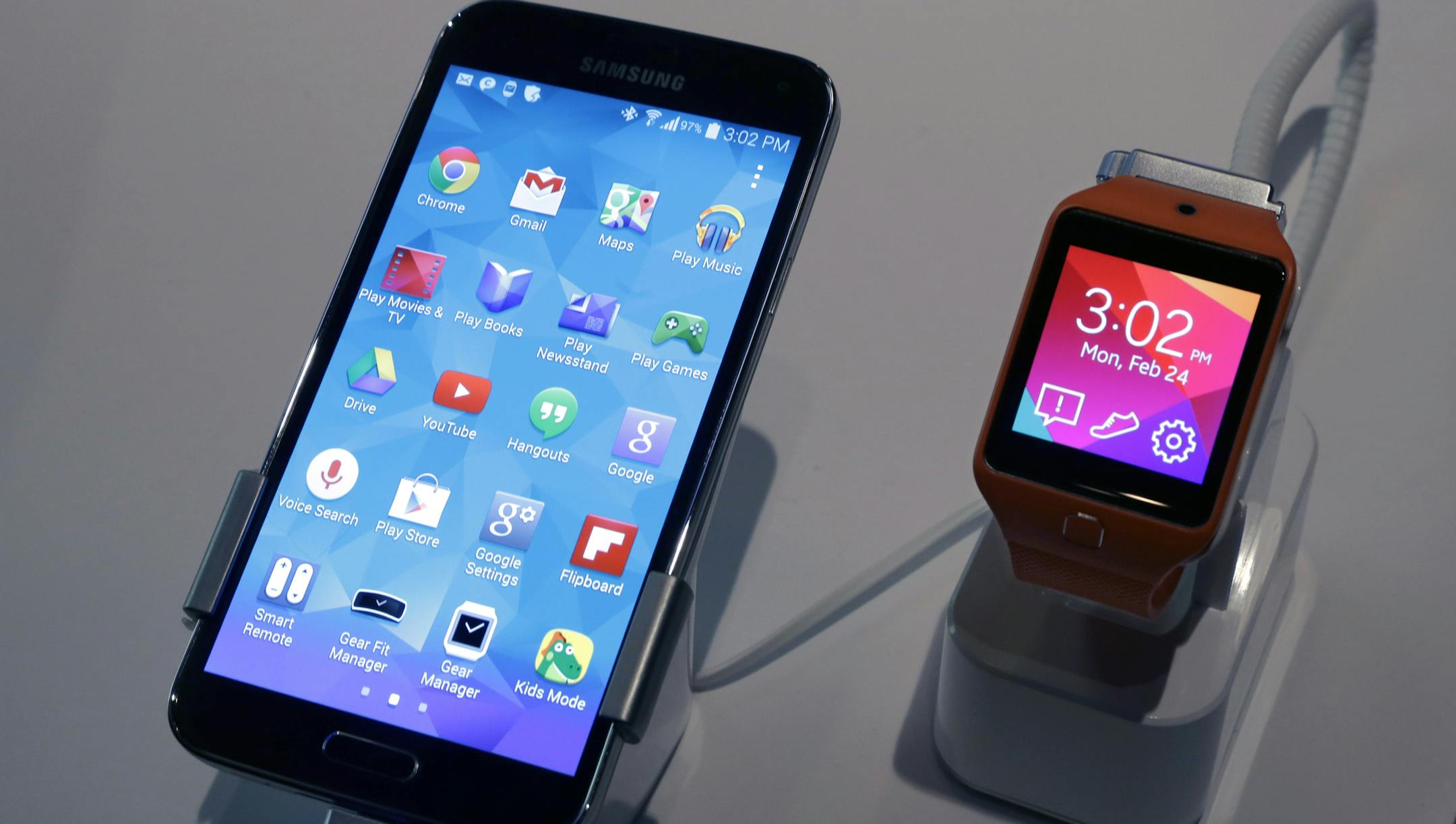 A Samsung Galaxy S5 smartphone, left, and a Samsung Gear 2 are displayed at the Samsung Galaxy Studio, in New York, Monday, Feb. 24, 2014. Samsung on Monday unveiled a new smartphone with a built-in heart rate monitor to complement three upcoming fitness devices, as the Korean company tries to turn its technological wizardry into lifestyle products. (AP Photo/Richard Drew)