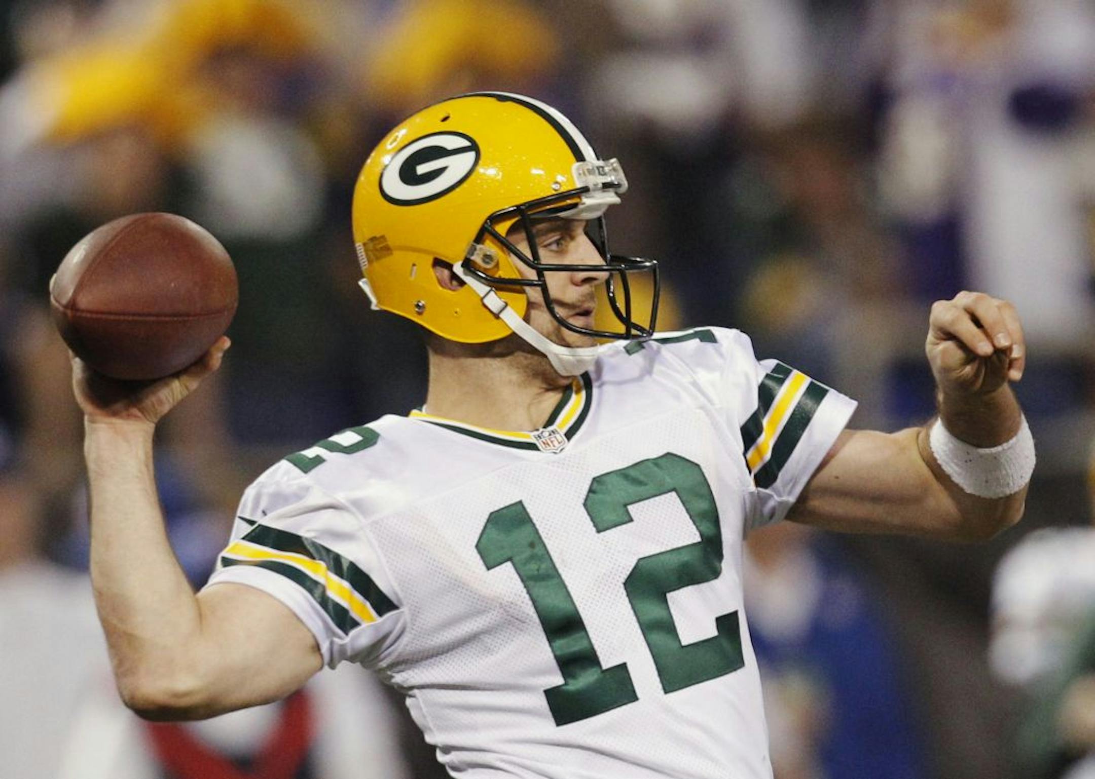 Green Bay Packers quarterback Aaron Rodgers (12) throws against the Minnesota Vikings during the second half of an NFL football game Sunday, Dec. 30, 2012, in Minneapolis.