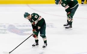 Kirill Kaprizov (97) and Joel Eriksson Ek (14) of the Wild react after losing to the Vegas Golden Knights in game 6 of the NHL Stanley Cup Playoffs at