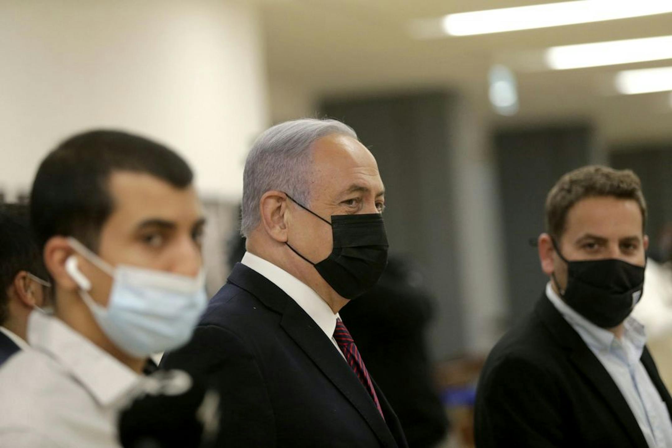 Israeli Prime Minister Benjamin Netanyahu, center, arrives at the Israeli Knesset (Parliament) ahead of a vote to dissolve the Knesset, in Jerusalem, Wednesday, Dec. 2 2020. The Israeli parliament passed a preliminary proposal to dissolve itself on Wednesday, setting up a possible fourth national election in under two years while the country is in the grip of the coronavirus pandemic.