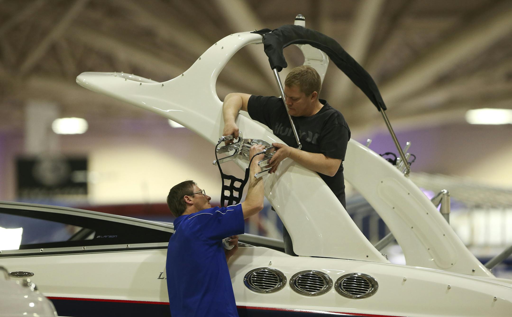 Preparations for the 2014 Minneapolis Boat Show were well underway Wednesday afternoon, January 29, 2014 on the eve of the show's opening at the Minneapolis Convention Center. Rob Salber, left, and Noah Wojahn installed a wake board rack on a Larson boat in the Larson Boats factory display at the boat show Wednesday afternoon. ] JEFF WHEELER ‚Ä¢ jeff.wheeler@startribune.com