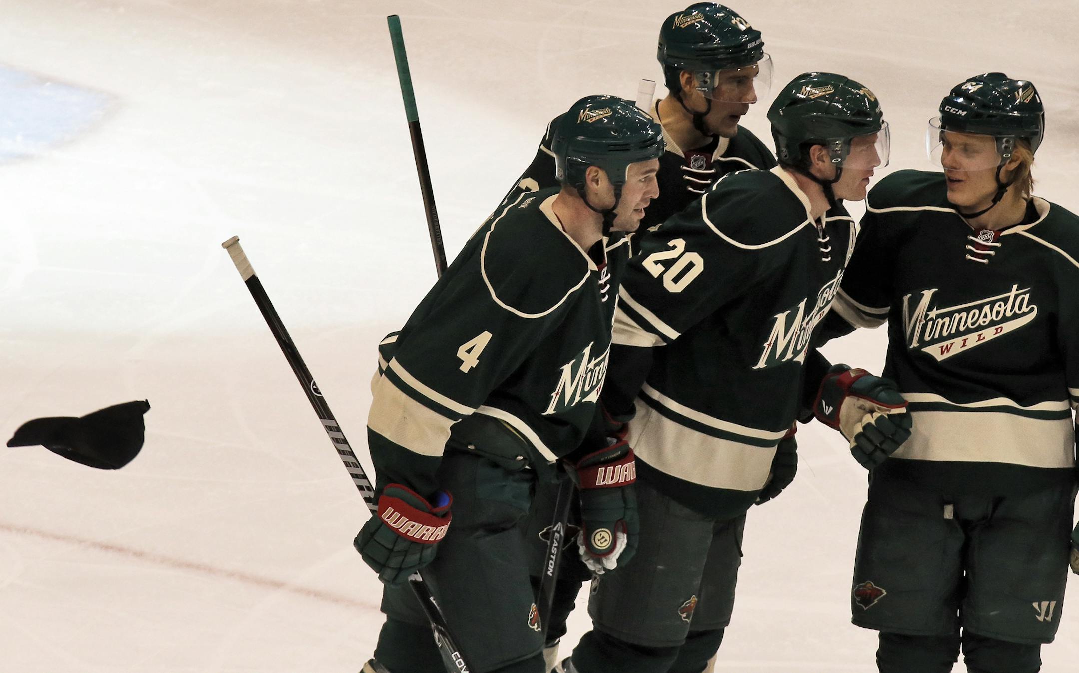 Minnesota Wild vs. Washington Capitols. Minnesota won 5-3. Wild's Ryan Suter scored three goals in the game. Wild players congratulate Ryan Suter (20) on his three goal "hat trick" night as a fan's hat comes flying on the ice. (MARLIN LEVISON/STARTRIBUNE(mlevison@startribune.com)