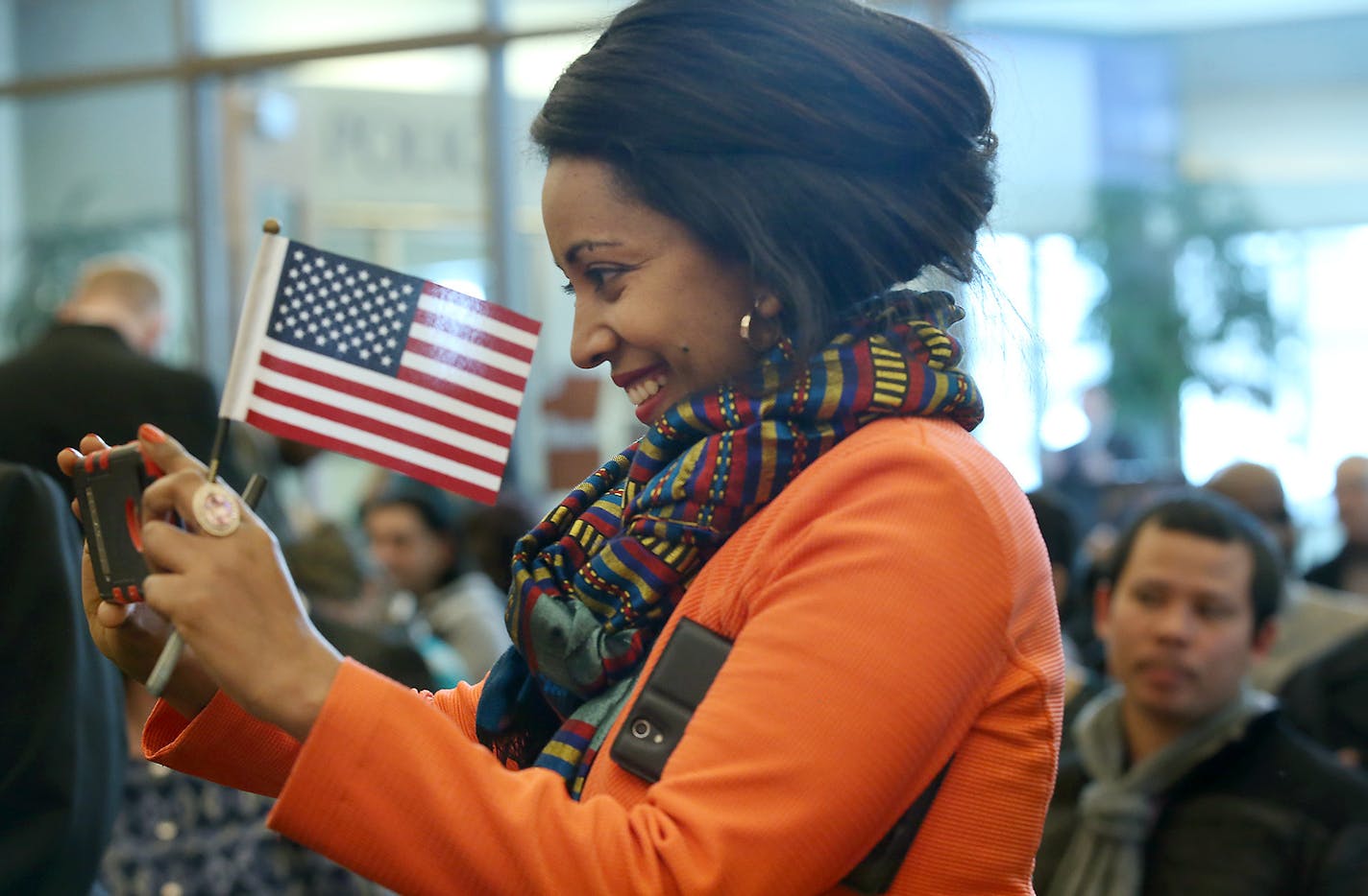 Senait Mengesha, cq, of Ethiopia, was all smiles after she received her citizenship and as she photographed others with her cell phone after a Citizen naturalization ceremony at the Richfield City Hall, Tuesday, February 16, 2016 in Richfield, MN. ] (ELIZABETH FLORES/STAR TRIBUNE) ELIZABETH FLORES &#x2022; eflores@startribune.com