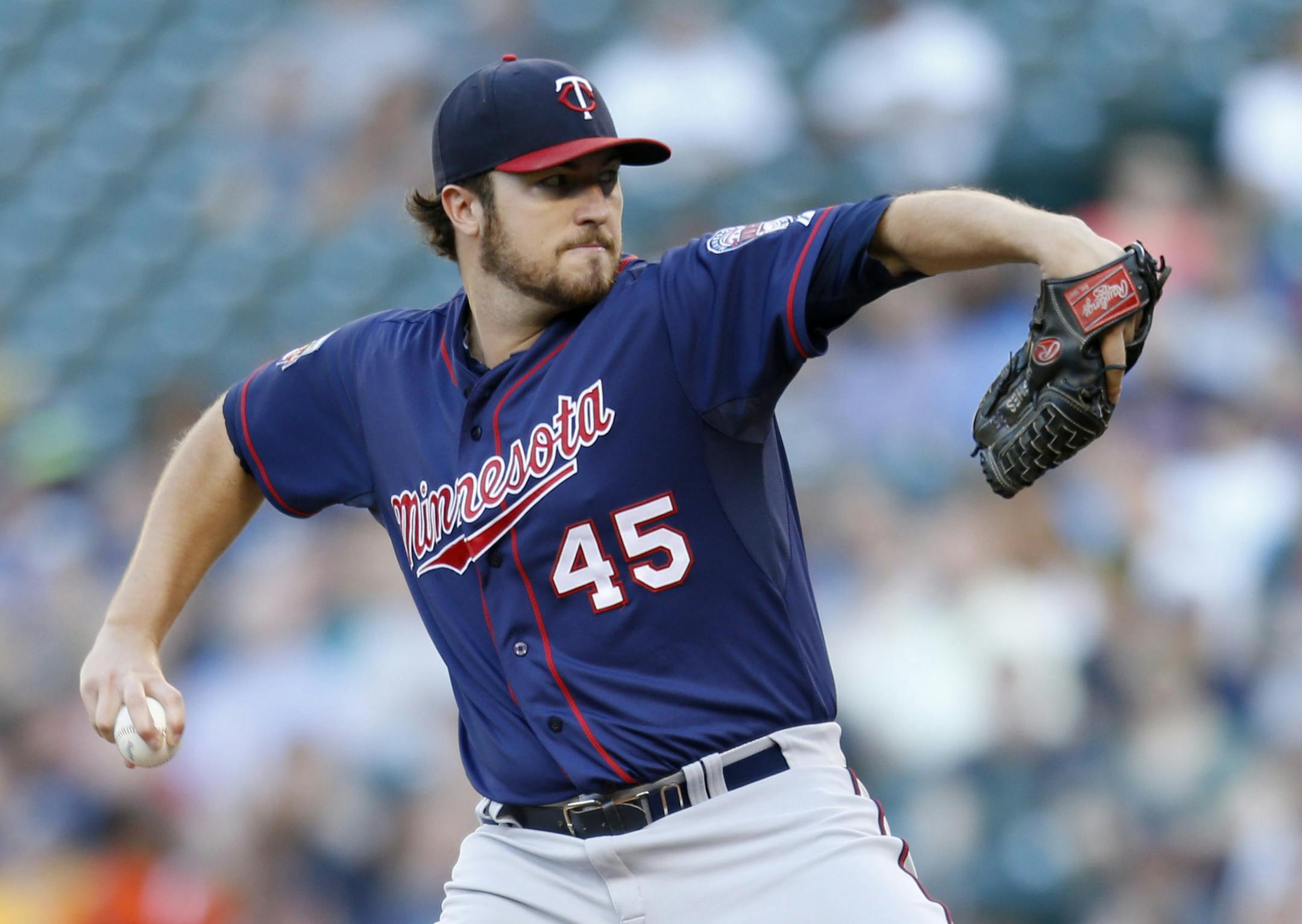 Minnesota Twins starting pitcher Phil Hughes throws against the Seattle Mariners during the first inning of a baseball game on Tuesday, July 8, 2014 in Seattle. (AP Photo/John Froschauer)