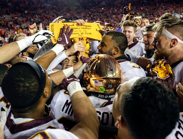 Gophers players celebrated with the Paul Bunyan Axe after beating Wisconsin 37-15 last season in Madison.