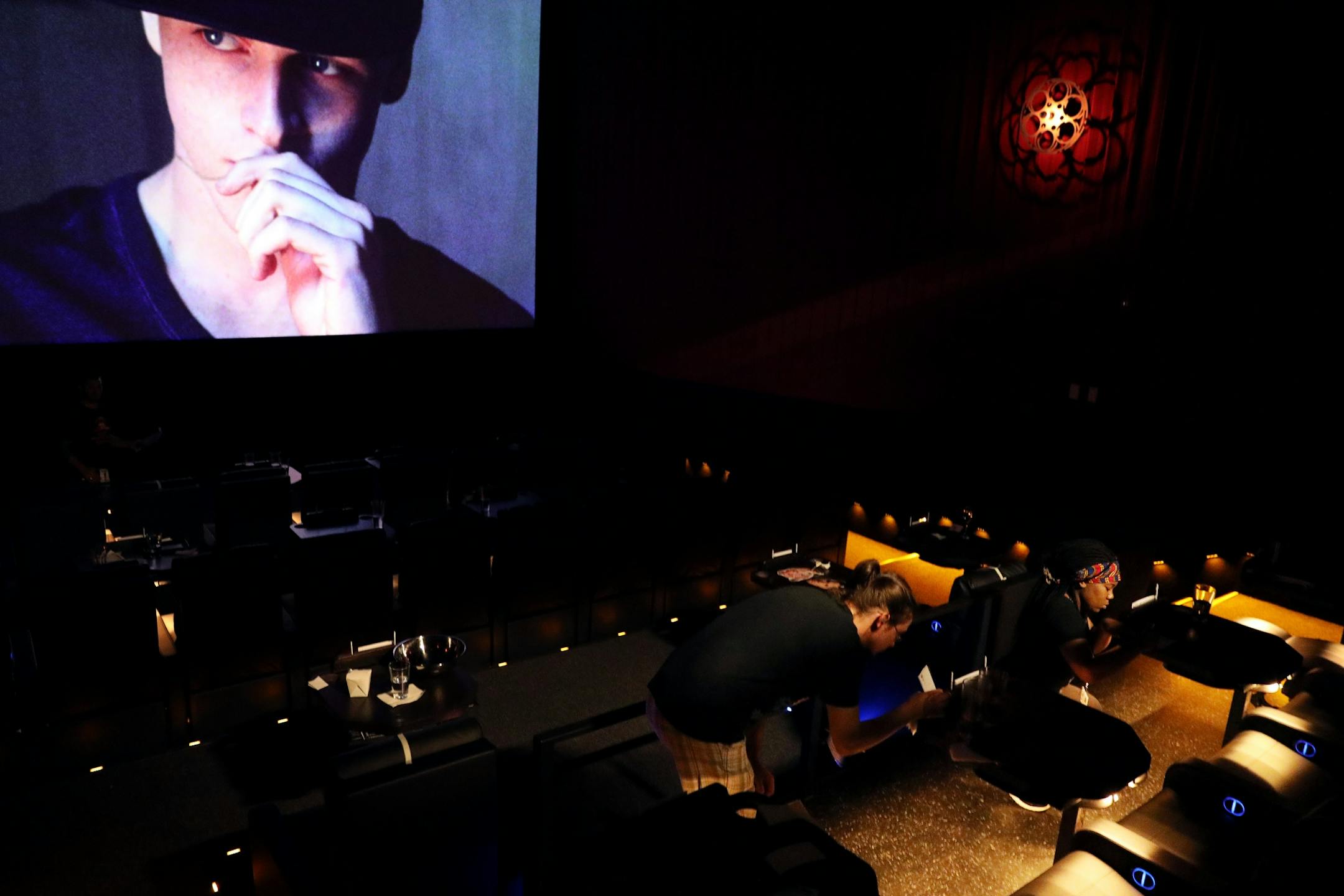 Staff practiced ducking past moviegoers and crouching to take food orders during a training session at Alamo Drafthouse Cinema.