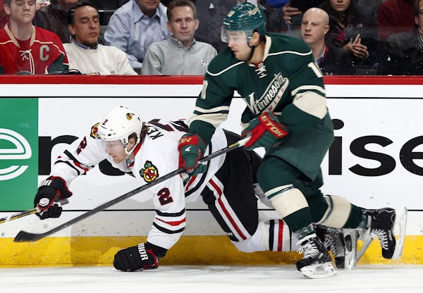 Duncan Keith (2) tangled up with Devin Setoguchi (10) in the third period.