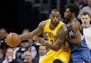 Cleveland Cavaliers' LeBron James, left, drives past Minnesota Timberwolves' Andrew Wiggins, from Canada, in the second half of an NBA basketball game