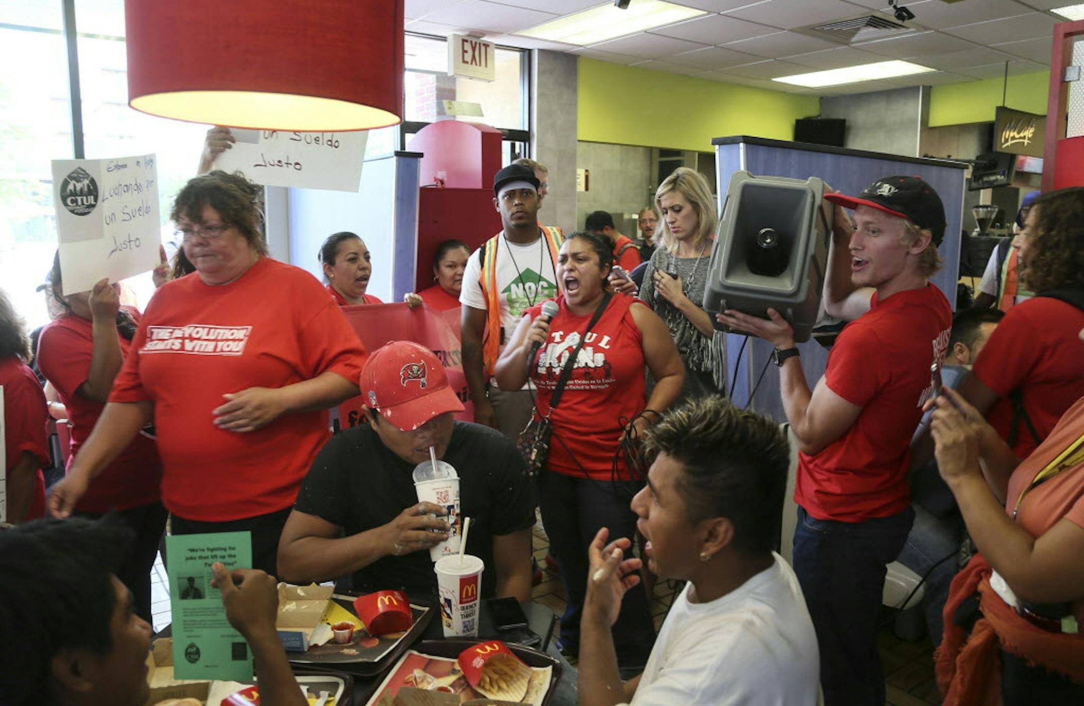 Food workers protested low wages and some struck to demand $15 an hour wages at the Uptown McDonalds Thursday, Sept. 4, 2014, in Minneapolis, MN. Here, Veronica Mendez Moore, center, with microphone, spoke by microphone to protestors inside the Uptown McDonalds .](DAVID JOLES/STARTRIBUNE)djoles@startribune.com Food workers protested low wages and some struck to demand $15 an hour wages at the Uptown McDonalds Thursday, Sept. 4, 2014. Some cities in America have implemented a $15 minimum wage.